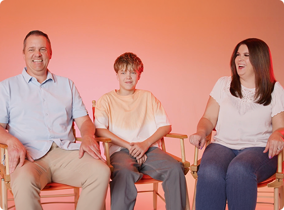 A family of three laughing together