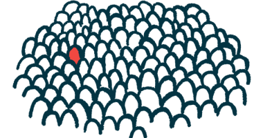 A person, the sole individual in red, stands out in a crowd of people.
