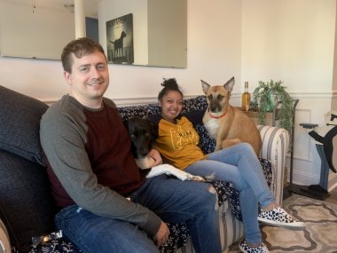 Cystic Fibrosis News Today | Nicole and Jared relax on a couch in their home with their two dogs.