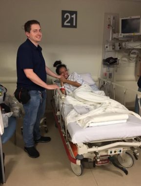 relationships and CF | Cystic Fibrosis News Today | Nicole lies in a hospital bed wearing a gown and covered with a blanket. She smiles and holds Jared's hand as he stands beside her.