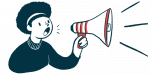 A person uses a megaphone to make an announcement.