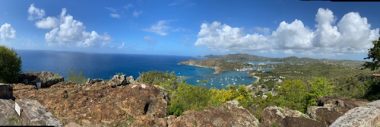 challenges of living with cystic fibrosis | Cystic Fibrosis News Today | A panoramic shot of the island of Antigua. Clear blue skies with a few fluffy, white clouds blend into the blue waters of the Caribbean. 