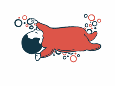 An infant in a red sleeper outfit is seen napping.