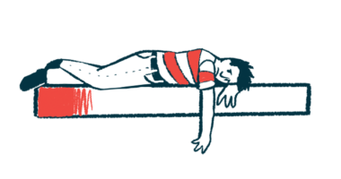 A person lies facedown on a bed with one arm hanging down.