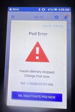 A photo of what looks like a phone screen with "Pod Error" at the top and a large exclamation point inside a red triangle.